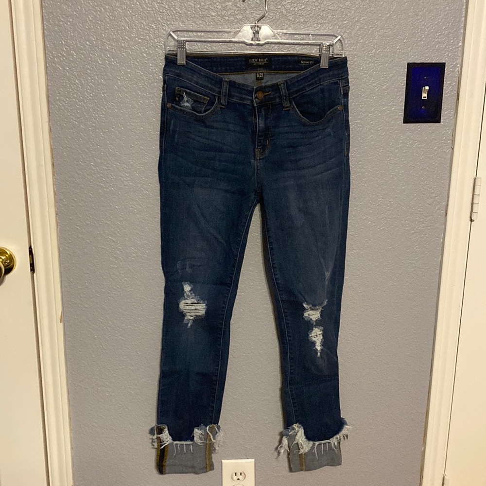 Judy Blue jeans. Skinny fit. Distressed. Down to the ankle. Raw hem is sewn up.